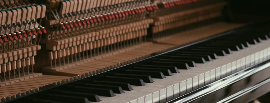 How do I find the serial number on an upright or grand piano?